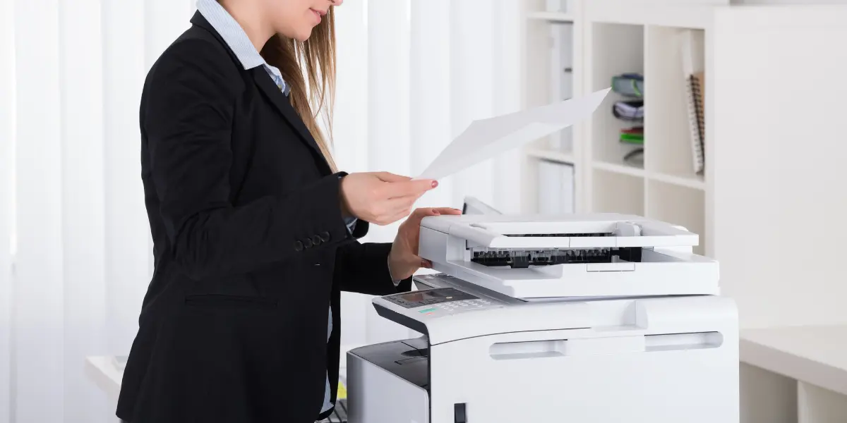Woman operating copy machine