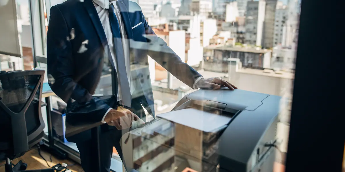 Business professional standing in office by copy machine