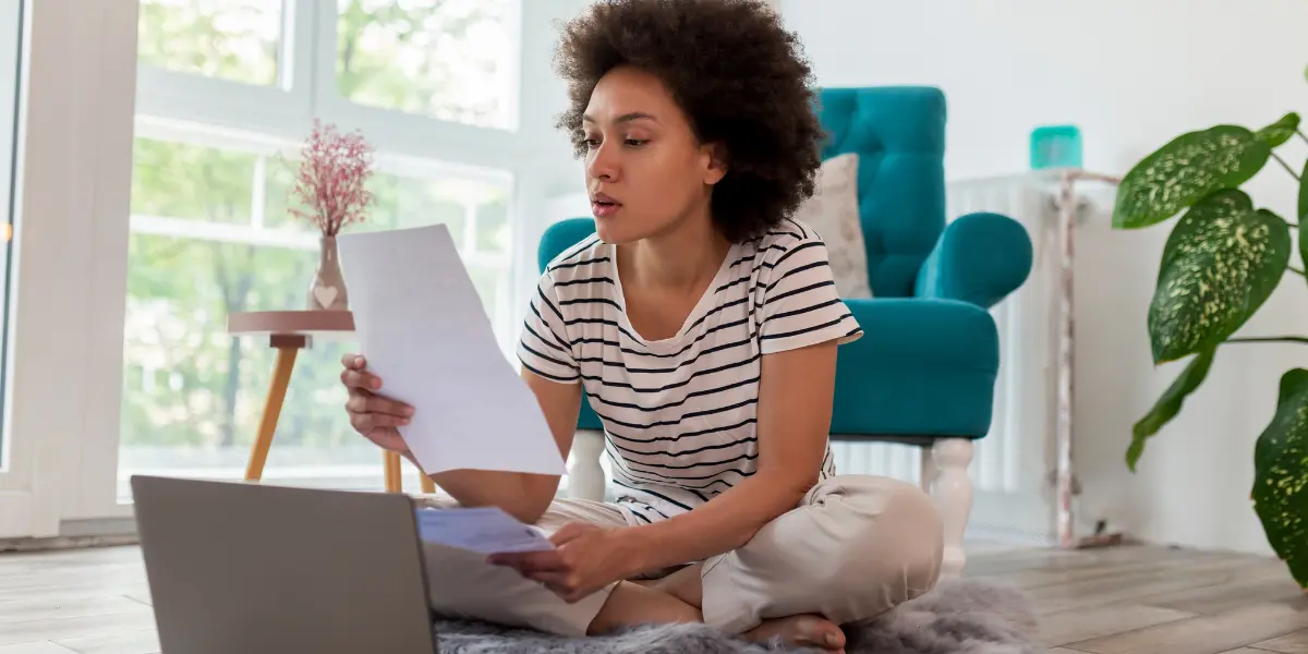 Woman looking over bills and determining the right printer for her business