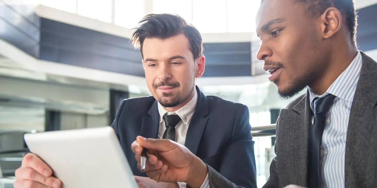 Business men looking over numbers and determining if they need managed print services