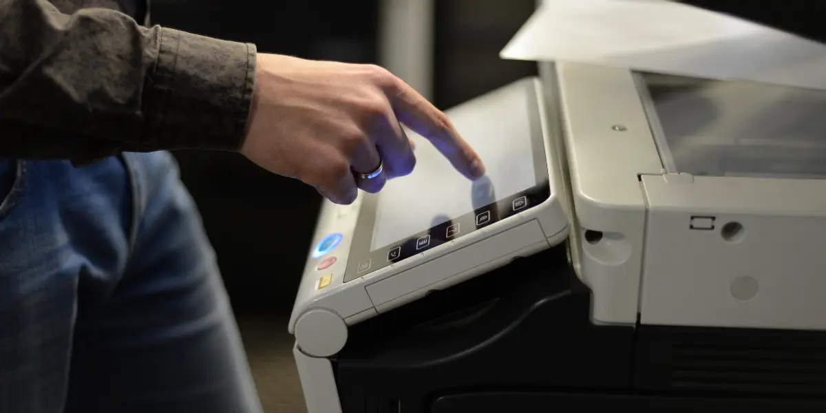 Business professional operating copy machine